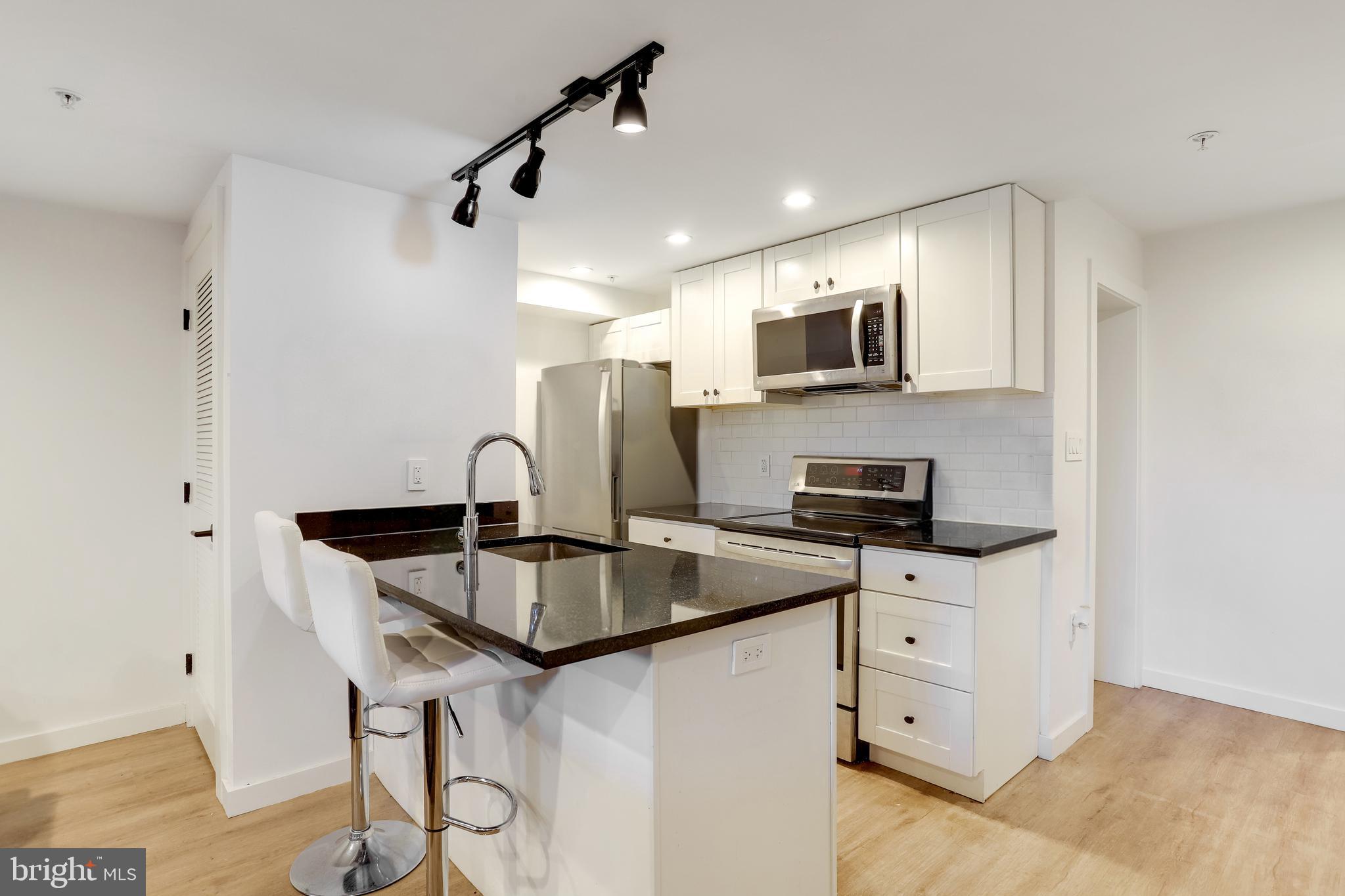 1920 35th Street Northwest Washington, DC 20007 - Photo 31 of 53 a kitchen with stainless steel appliances granite countertop a stove and a sink