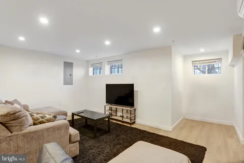 a view of a living room kitchen and a wooden floor