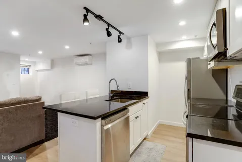 a view of a kitchen with a sink and cabinets