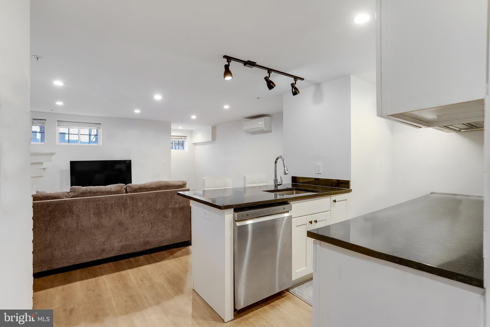 1920 35th Street Northwest Washington, DC 20007 - Photo 39 of 53 a living room with stainless steel appliances kitchen island a stove and a sink