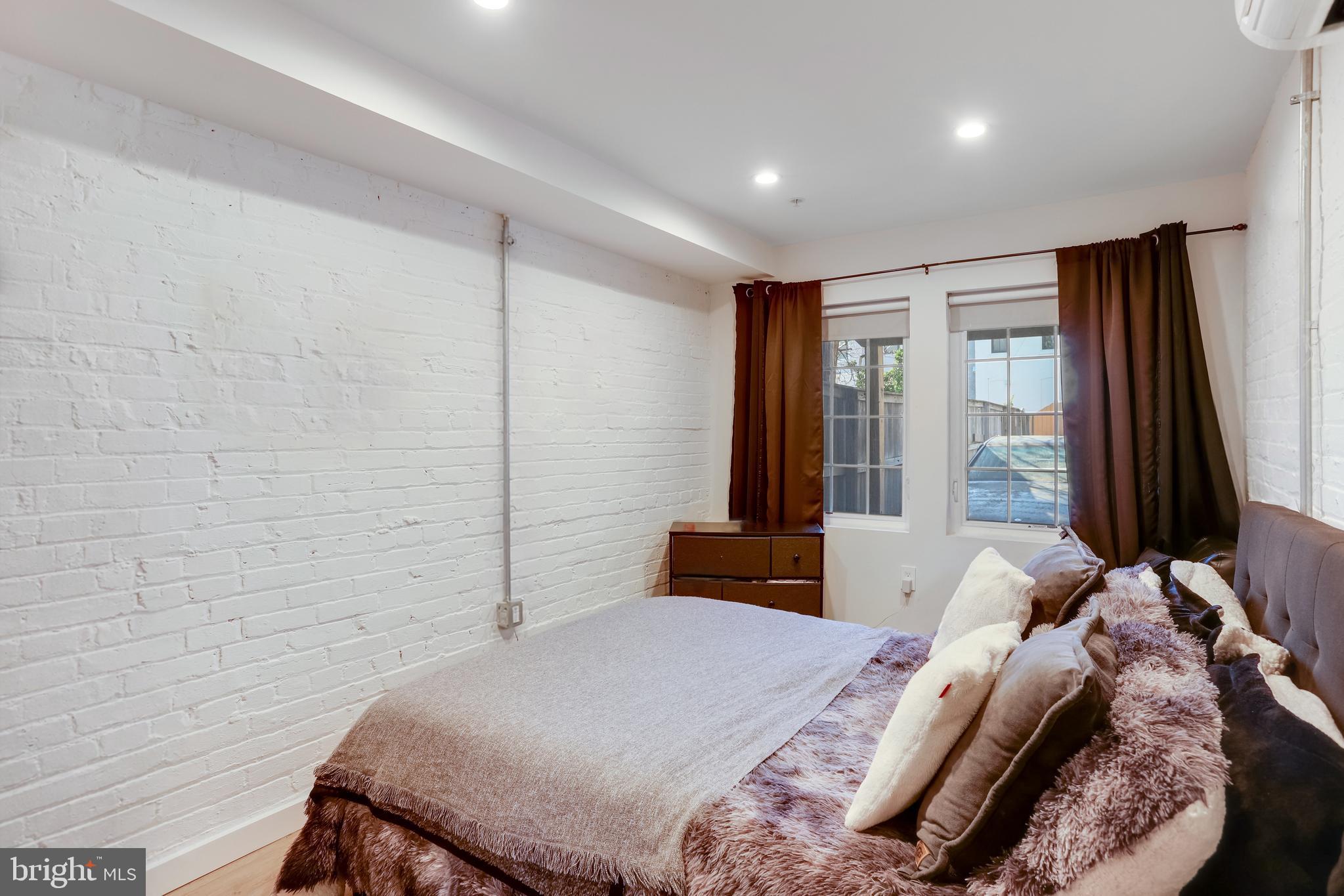 1920 35th Street Northwest Washington, DC 20007 - Photo 41 of 53 a bedroom with a bed and a flat tv screen