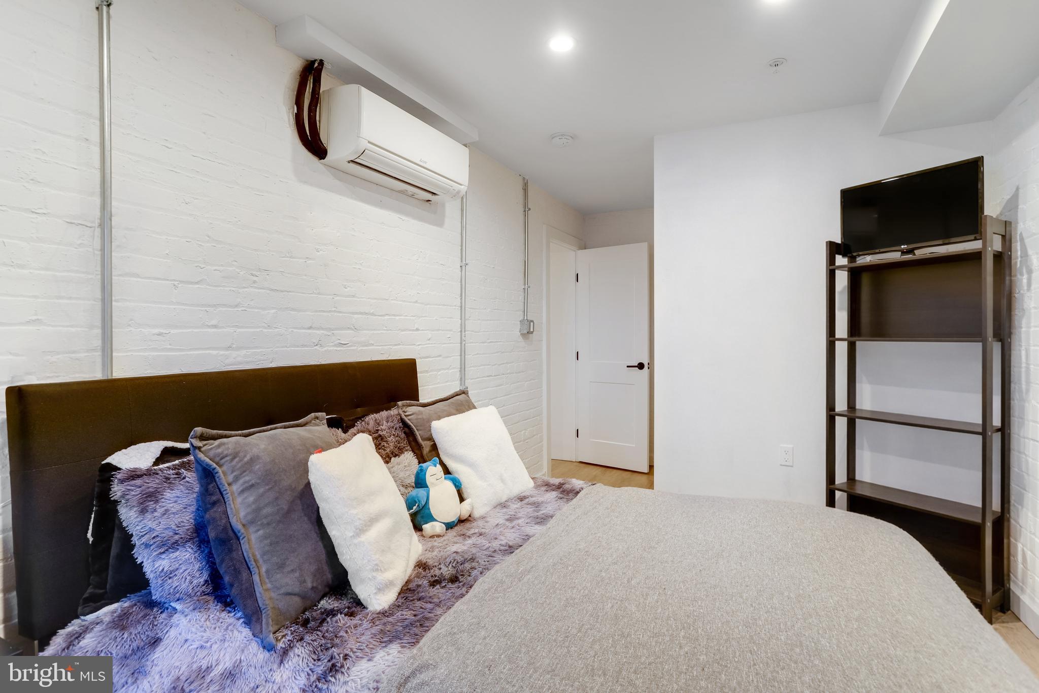 1920 35th Street Northwest Washington, DC 20007 - Photo 42 of 53 a bed room with a bed and a television