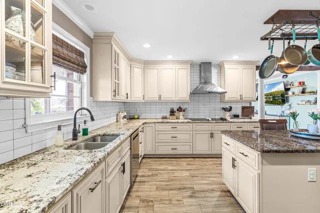a kitchen with stainless steel appliances granite countertop a sink stove and cabinets