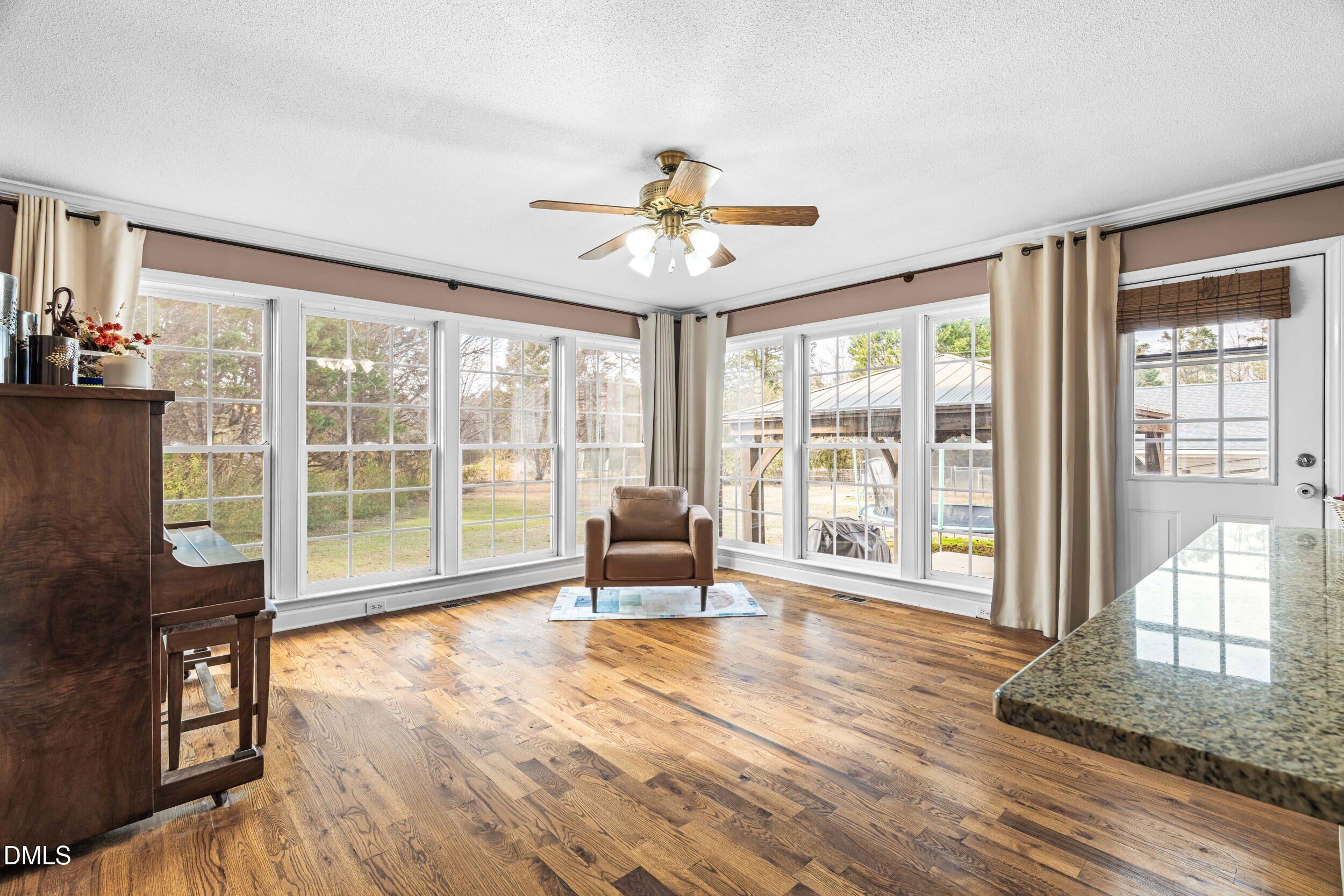 855 Debro Road Kenly, NC 27542 - Photo 20 of 41 a living room filled with furniture and floor to ceiling windows