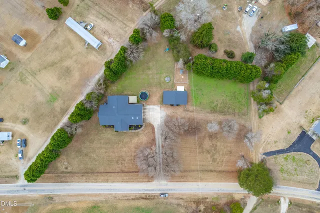 an aerial view of a house with yard