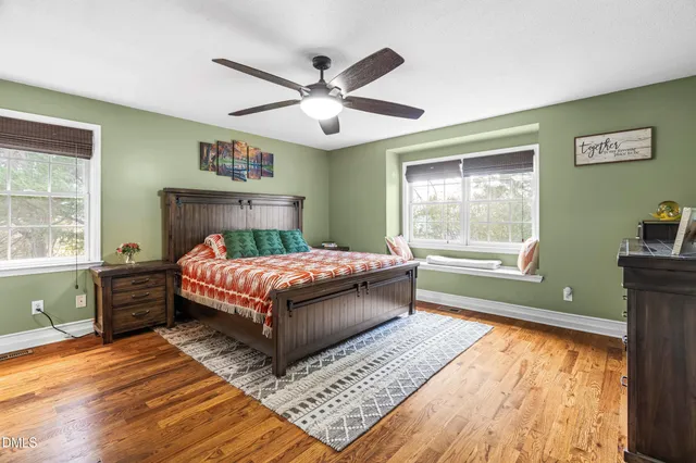 a bedroom with a large bed and a window