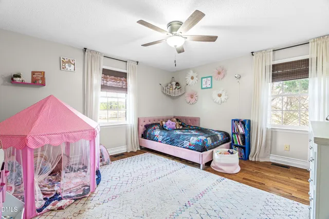 a bedroom with furniture and a window