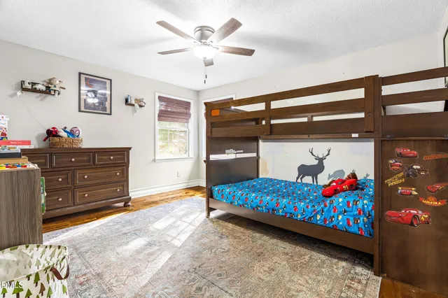 a bedroom with a bed and a dresser in it