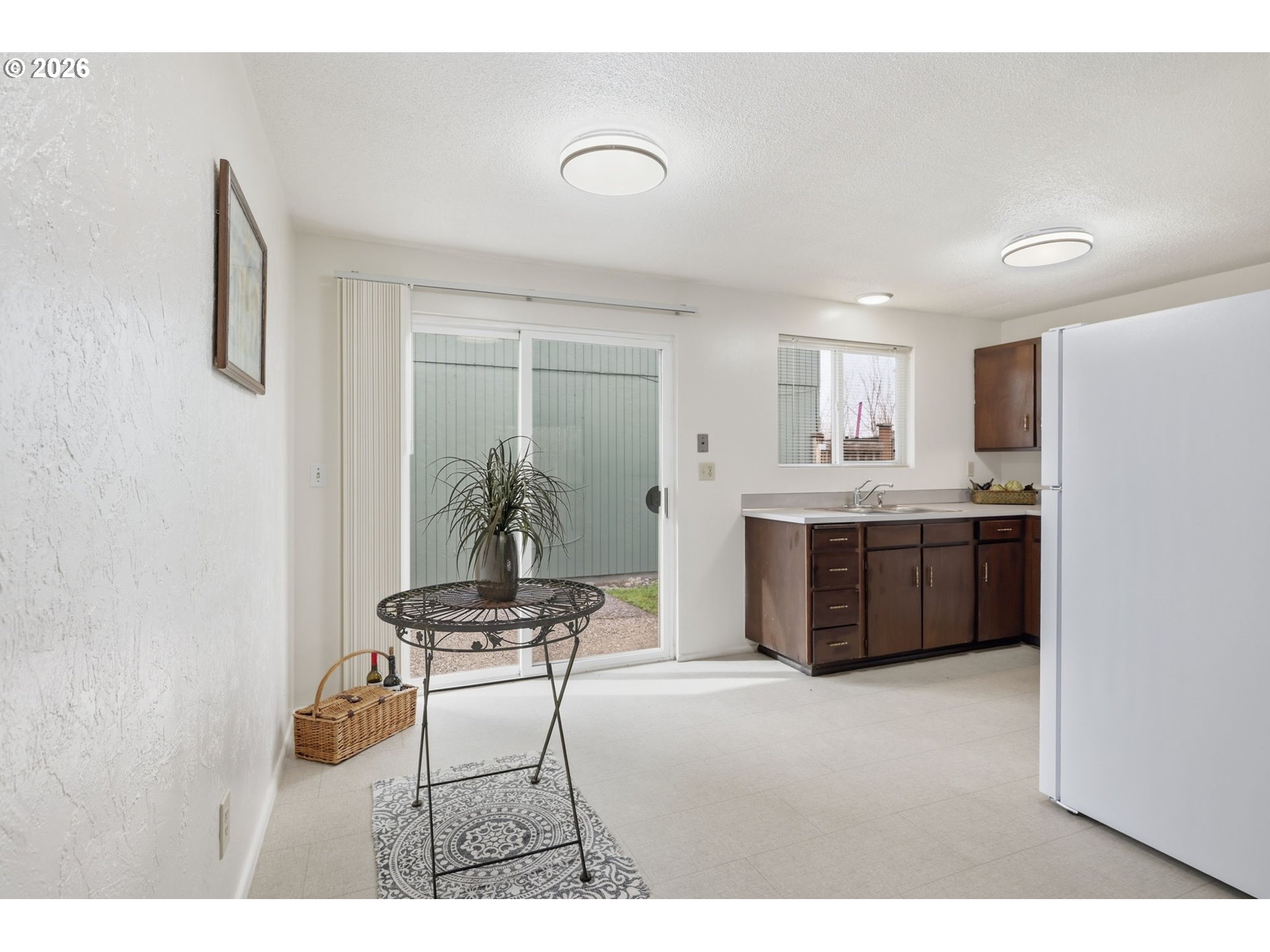 1674 Hayes Street, Unit B Eugene, OR 97402 - Photo 11 of 30 a kitchen with stainless steel appliances kitchen island a table chairs in it and a window