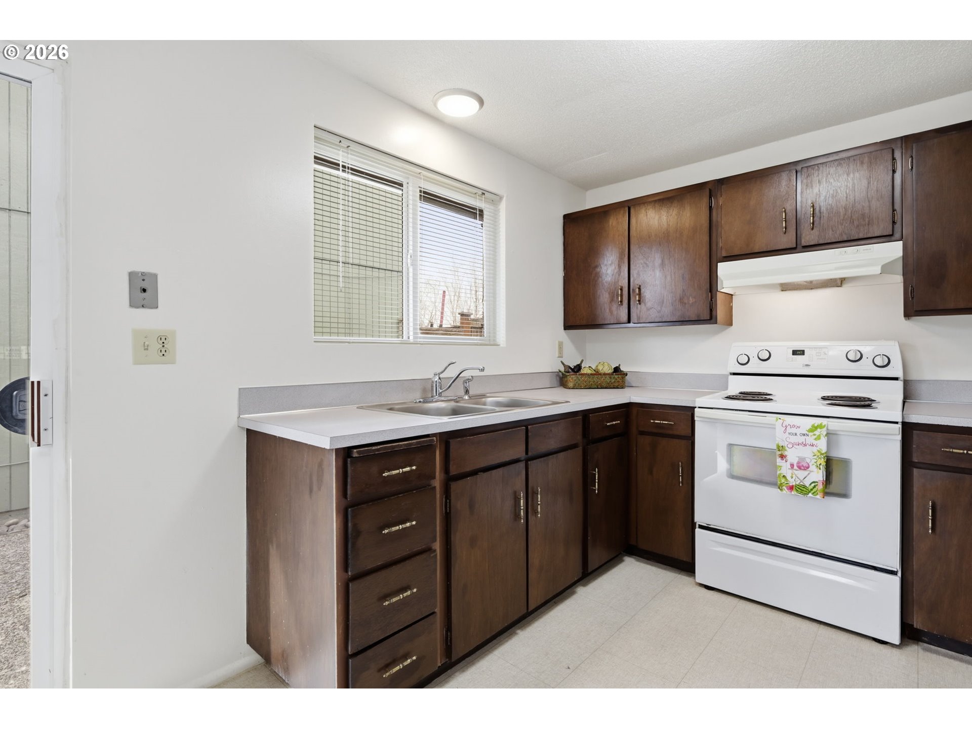 1674 Hayes Street, Unit B Eugene, OR 97402 - Photo 13 of 30 a kitchen with sink cabinets and white appliances