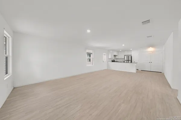 a kitchen with stainless steel appliances granite countertop a refrigerator stove and sink
