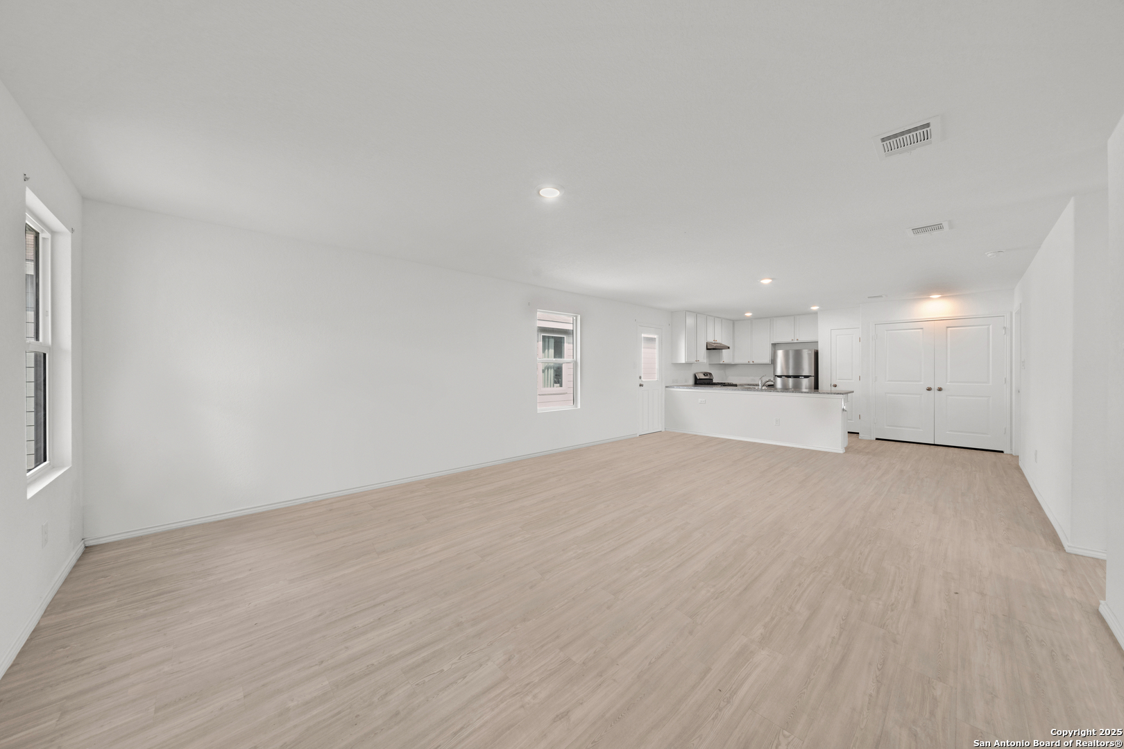242 Ambush Ridge San Antonio, TX 78220 - Photo 6 of 15 a view of empty room with kitchen and window