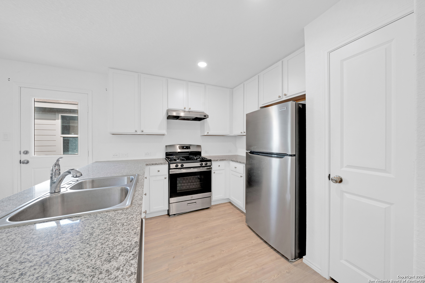 242 Ambush Ridge San Antonio, TX 78220 - Photo 7 of 15 a kitchen with stainless steel appliances granite countertop a refrigerator stove and sink