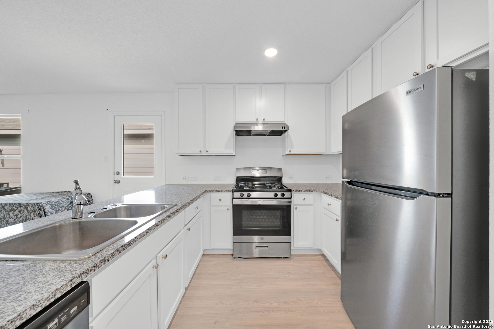 242 Ambush Ridge San Antonio, TX 78220 - Photo 8 of 15 a kitchen with a refrigerator sink and stove