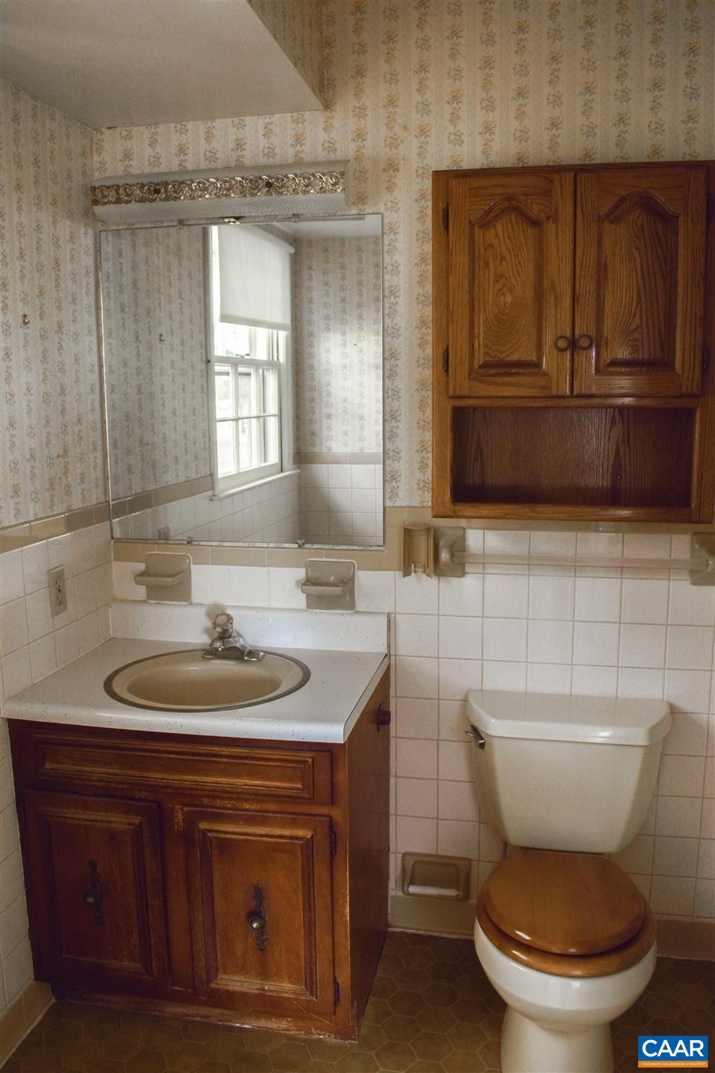 2429 Huntington Road Charlottesville, VA 22901 - Photo 22 of 32 a bathroom with a toilet a sink and mirror