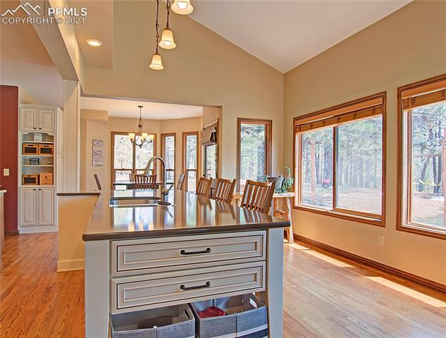 735 Winding Hills Road Monument, CO 80132 - Photo 8 of 42 Kitchen is light and bright with large windows and lots of space to entertain.