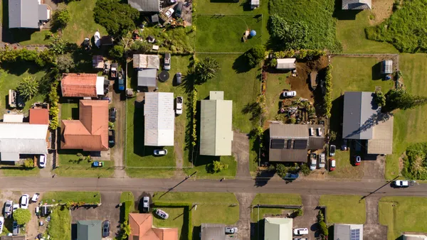 an aerial view of residential houses with outdoor space