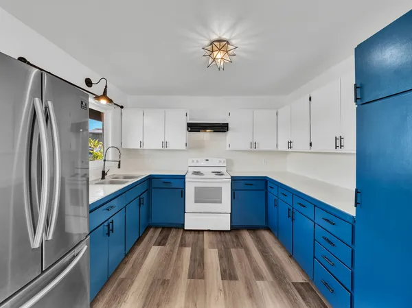 a kitchen with stainless steel appliances a refrigerator sink and cabinets