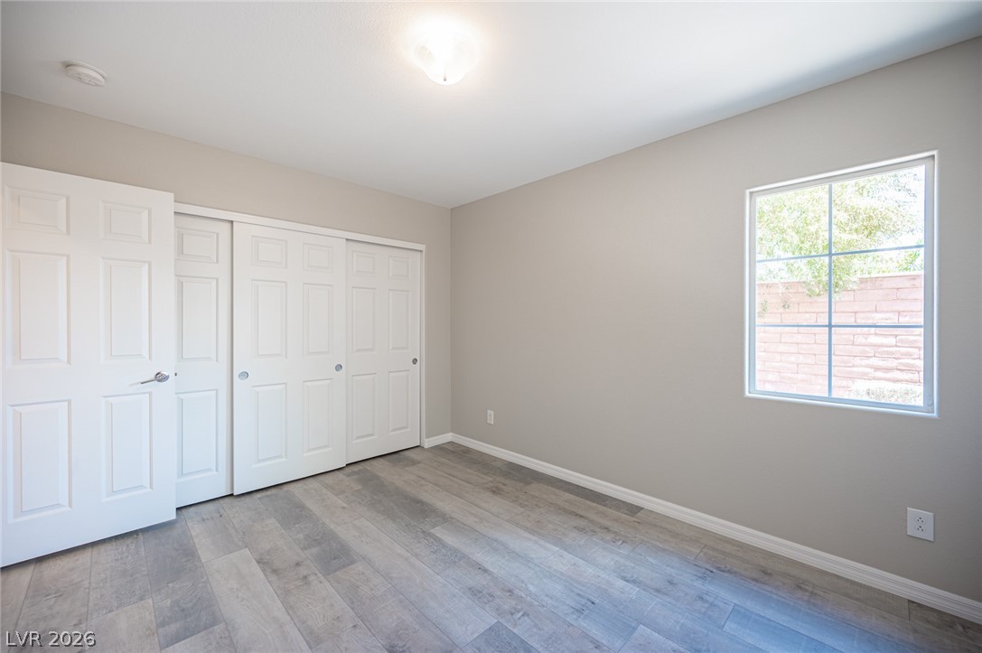 9916 Sable Point Street Las Vegas, NV 89178 - Photo 18 of 73 A well-lit room featuring durable flooring and ample closet storage, offering a versatile living space.