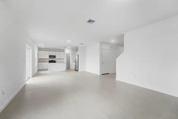a view of a big room with a kitchen