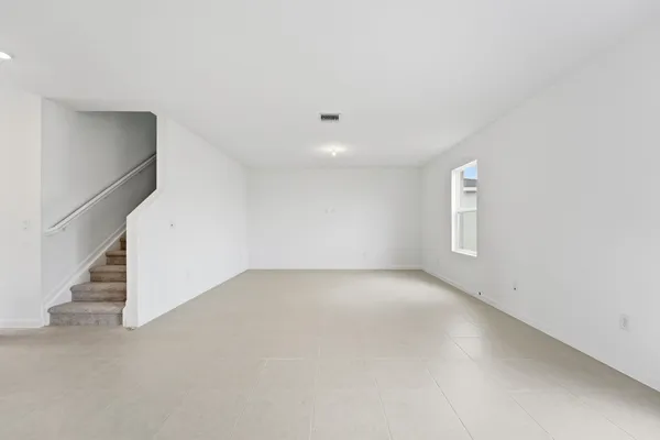 a view of an empty room with stairs