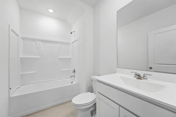 a bathroom with a sink toilet vanity and shower