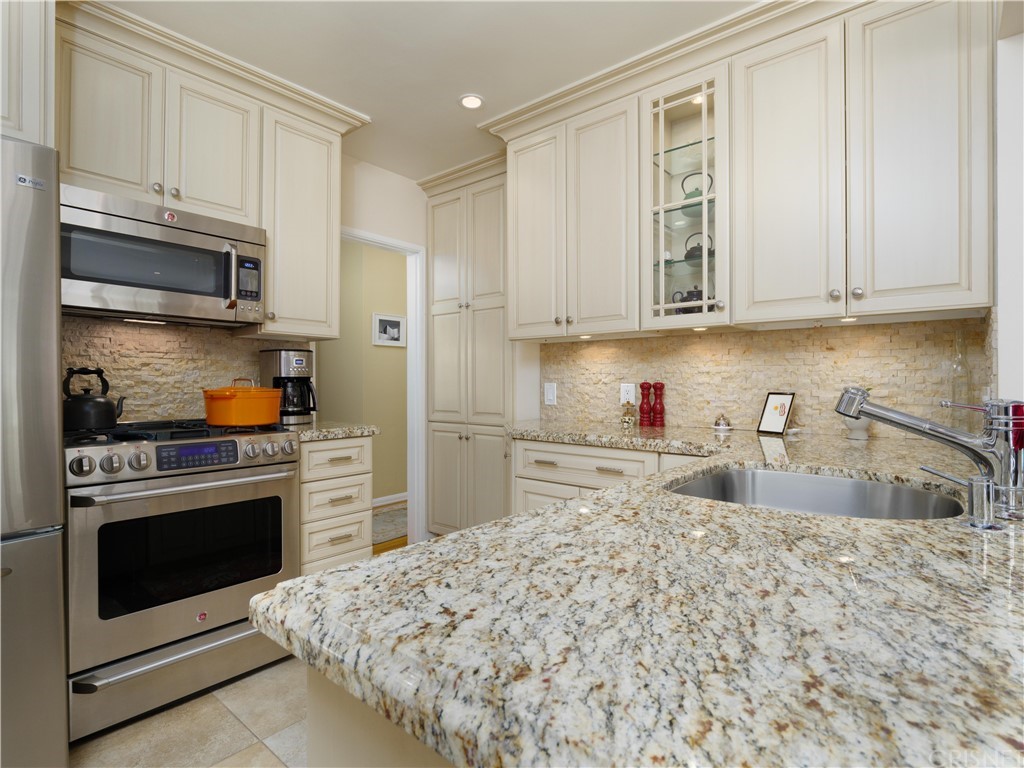 1122 North Niagara Street Burbank, CA 91505 - Photo 12 of 39 a kitchen with stainless steel appliances granite countertop a stove a sink and a refrigerator