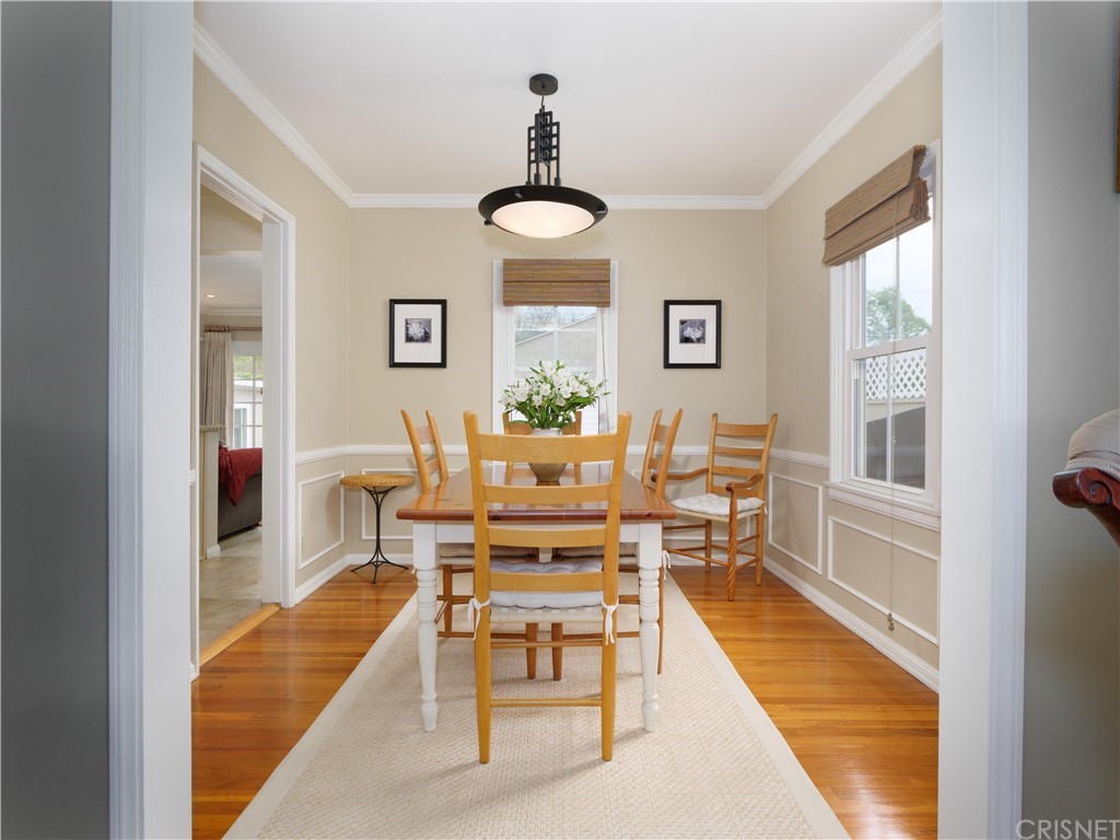 1122 North Niagara Street Burbank, CA 91505 - Photo 7 of 39 a dining room with wooden floor and a chandelier