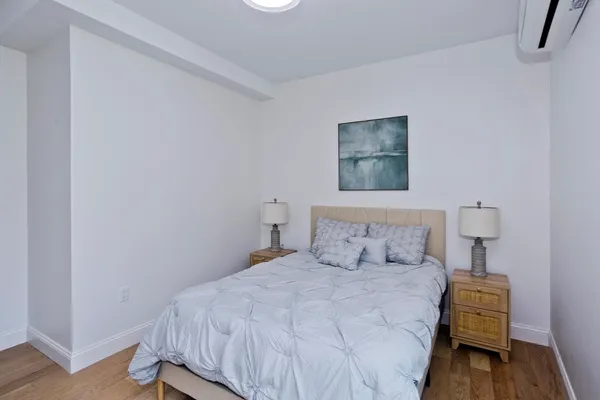 a bedroom with a bed and a night stand
