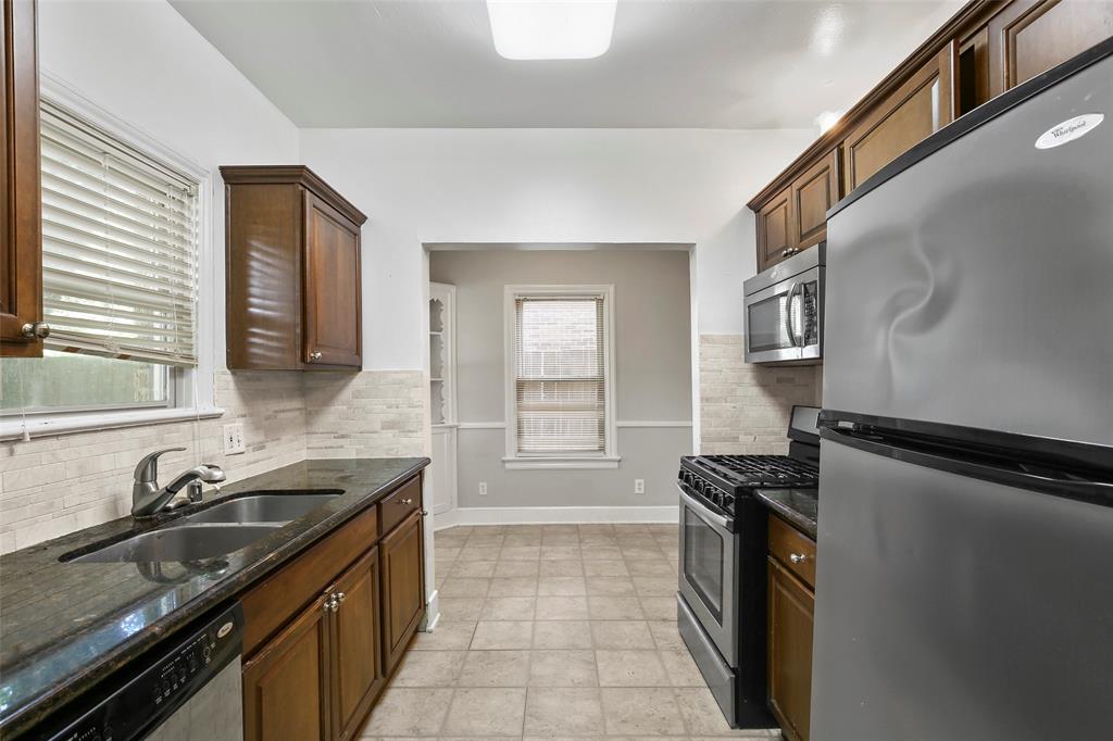 6166 Oram Street Dallas, TX 75214 - Photo 13 of 25 a kitchen with a sink appliances and cabinets