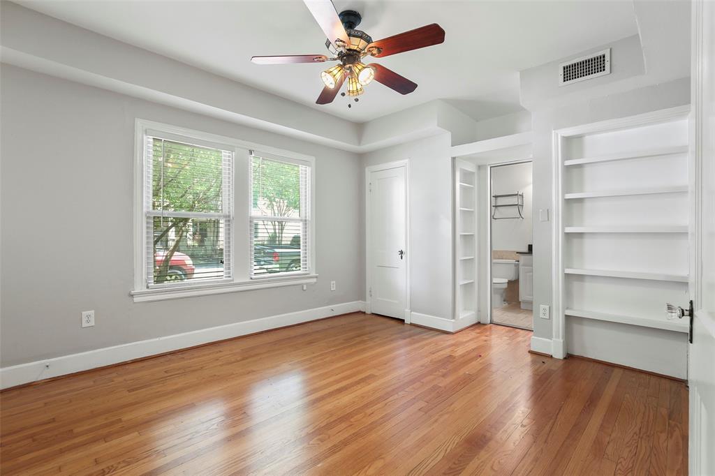 6166 Oram Street Dallas, TX 75214 - Photo 20 of 25 a view of an empty room with a window and wooden floor