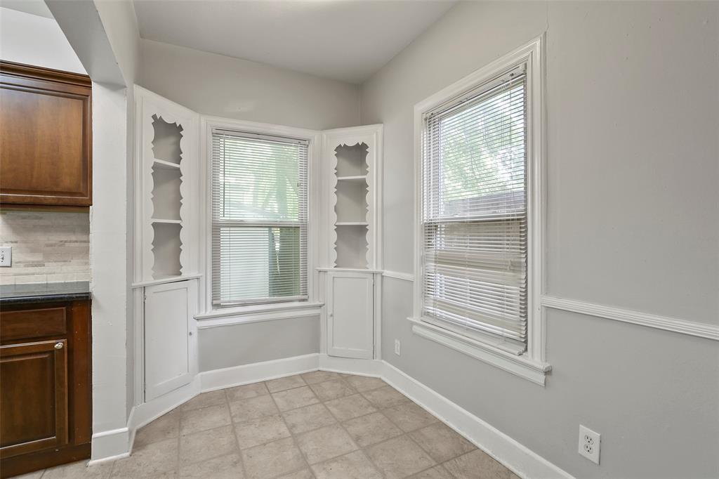 6166 Oram Street Dallas, TX 75214 - Photo 10 of 25 a view of an empty room with cabinet and a window