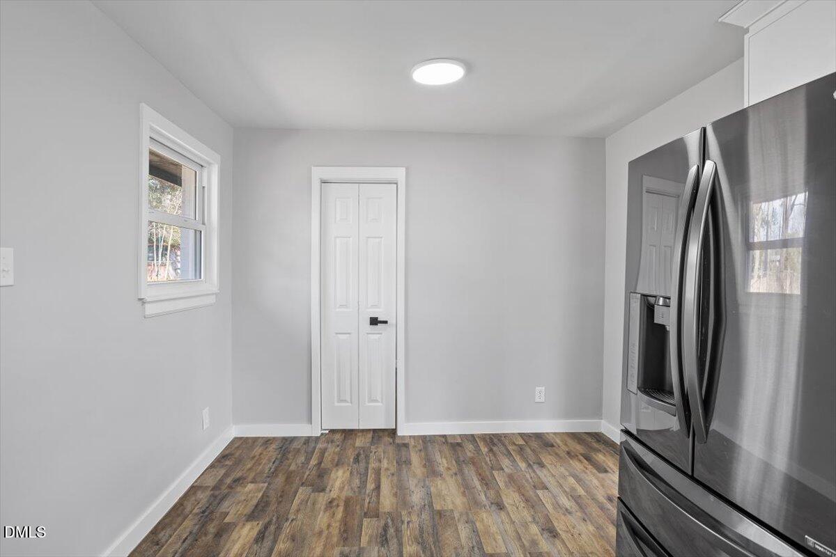 1905 Capps Street Durham, NC 27707 - Photo 12 of 35 a view of an empty room with wooden floor and a window