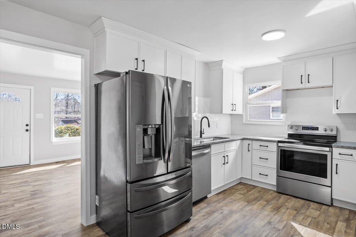 1905 Capps Street Durham, NC 27707 - Photo 13 of 35 a kitchen with stainless steel appliances a refrigerator sink and microwave