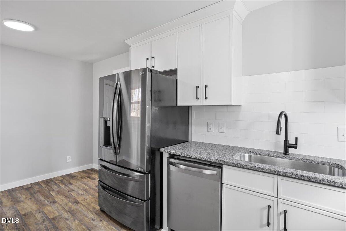 1905 Capps Street Durham, NC 27707 - Photo 14 of 35 a kitchen with granite countertop a refrigerator sink and cabinets