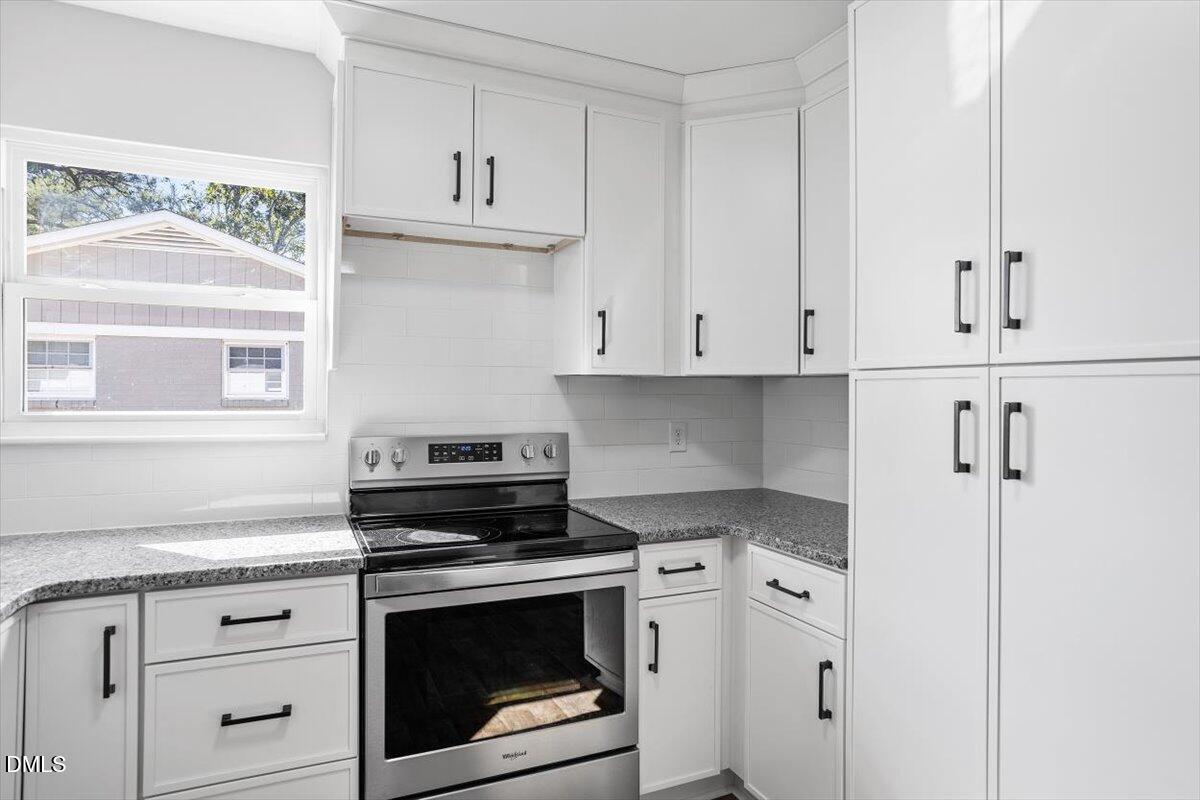 1905 Capps Street Durham, NC 27707 - Photo 16 of 35 a kitchen with white cabinets and appliances