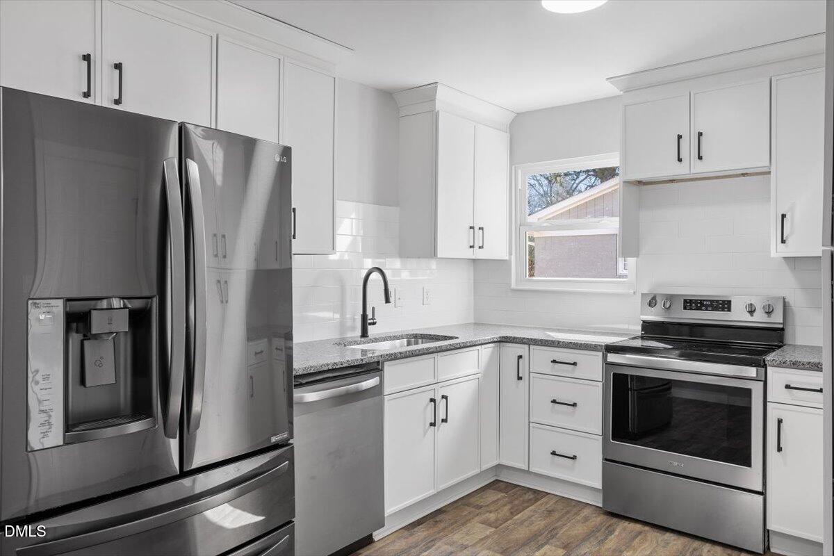 1905 Capps Street Durham, NC 27707 - Photo 17 of 35 a kitchen with stainless steel appliances cabinets a refrigerator and a stove
