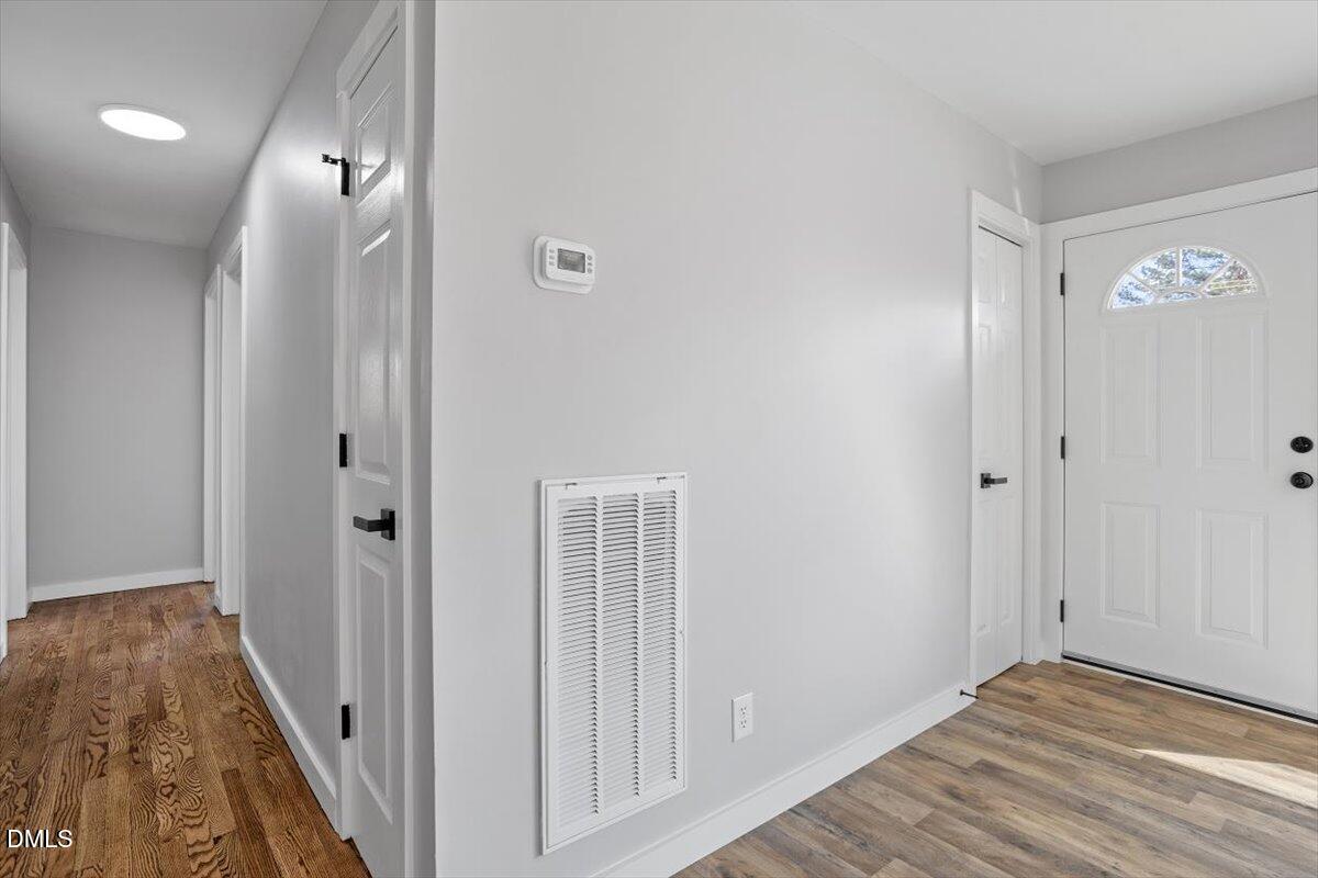 1905 Capps Street Durham, NC 27707 - Photo 20 of 35 a view of a hallway with wooden floor and staircase