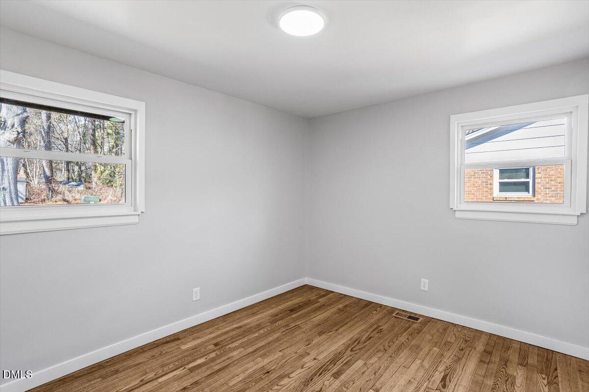 1905 Capps Street Durham, NC 27707 - Photo 21 of 35 a view of an empty room with wooden floor and a window