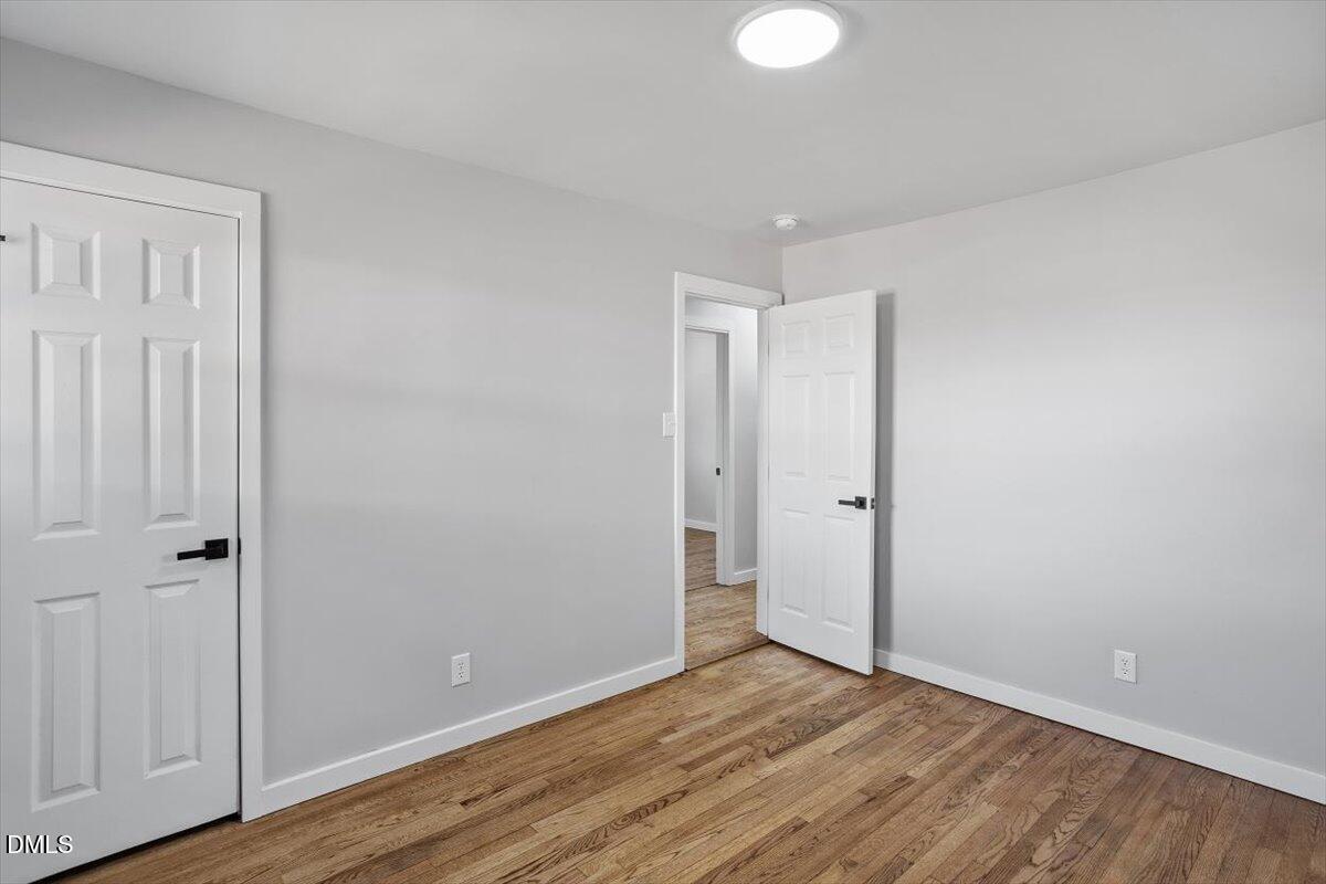 1905 Capps Street Durham, NC 27707 - Photo 22 of 35 a view of an empty room and wooden floor