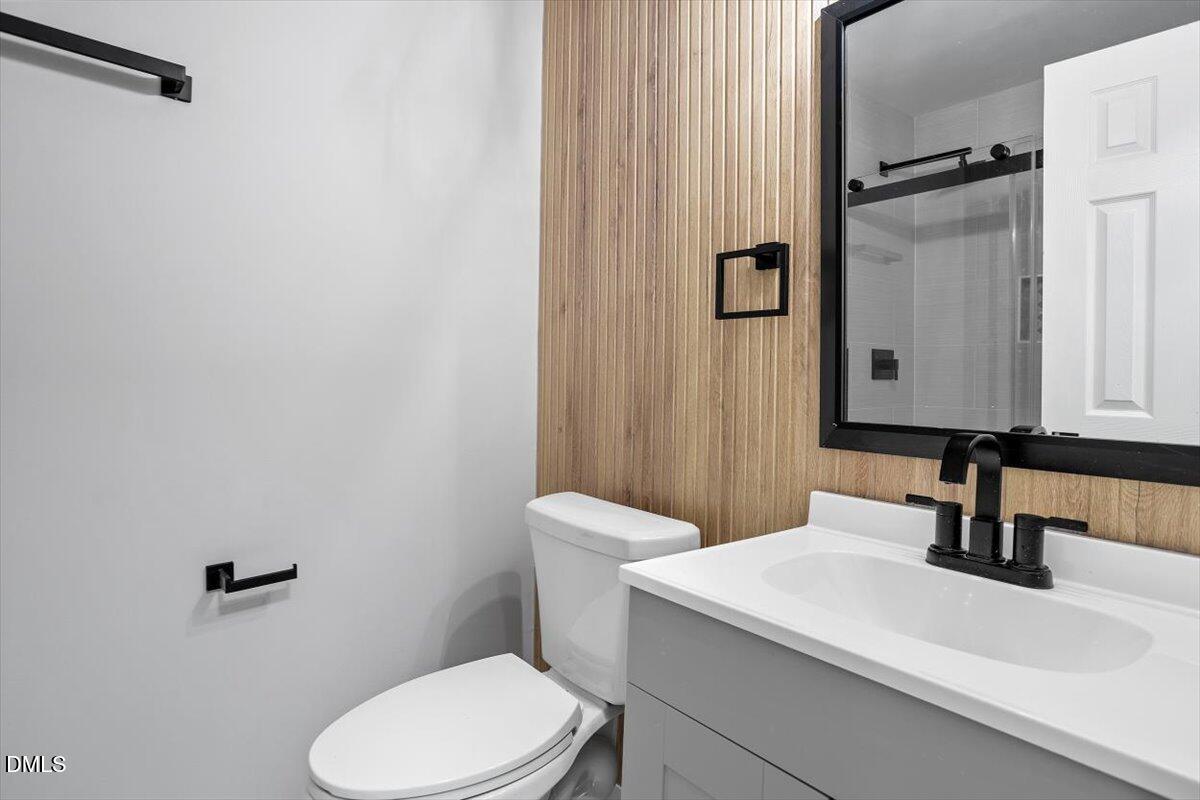 1905 Capps Street Durham, NC 27707 - Photo 24 of 35 a bathroom with a sink a toilet and mirror