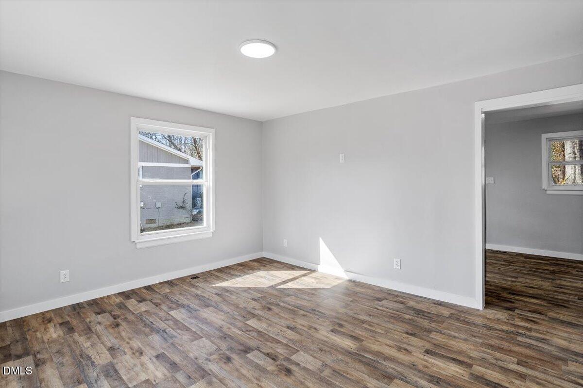 1905 Capps Street Durham, NC 27707 - Photo 5 of 35 a view of an empty room with wooden floor and a window