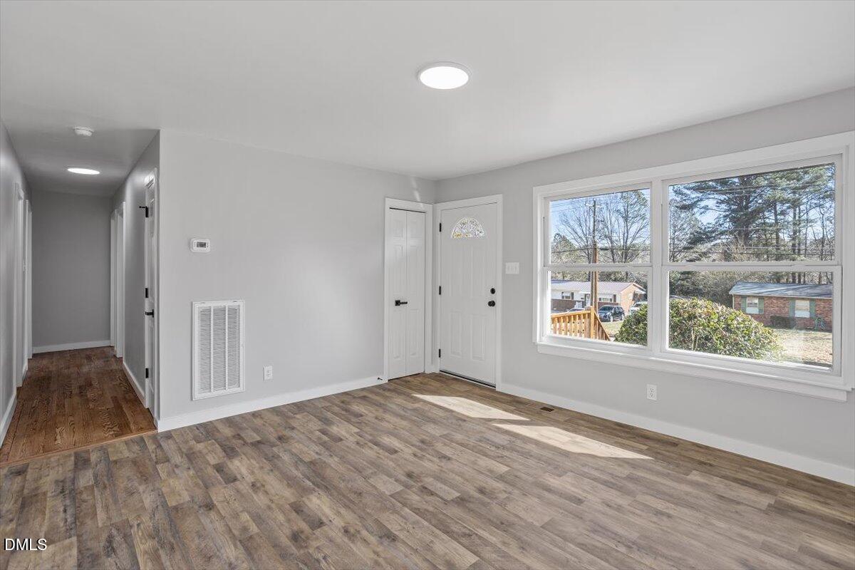 1905 Capps Street Durham, NC 27707 - Photo 7 of 35 a view of empty room with wooden floor and fan