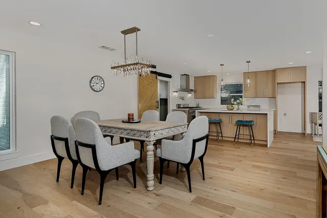 a view of a dining room with furniture and wooden floor