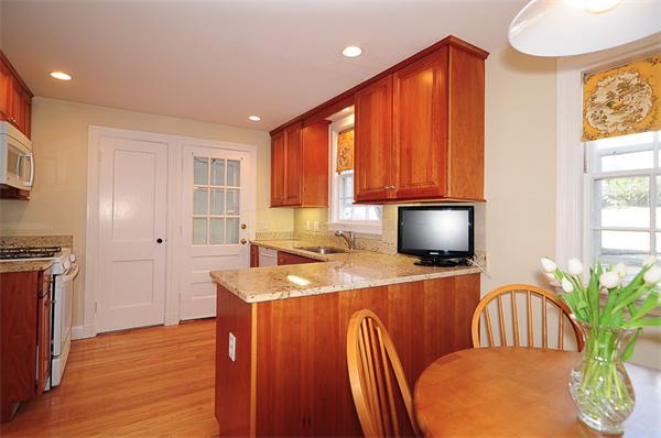 1 Alba Road Wellesley, MA 02481 - Photo 6 of 18 a kitchen with stainless steel appliances granite countertop a stove a sink dishwasher a microwave oven with a dining table and chairs with wooden floor