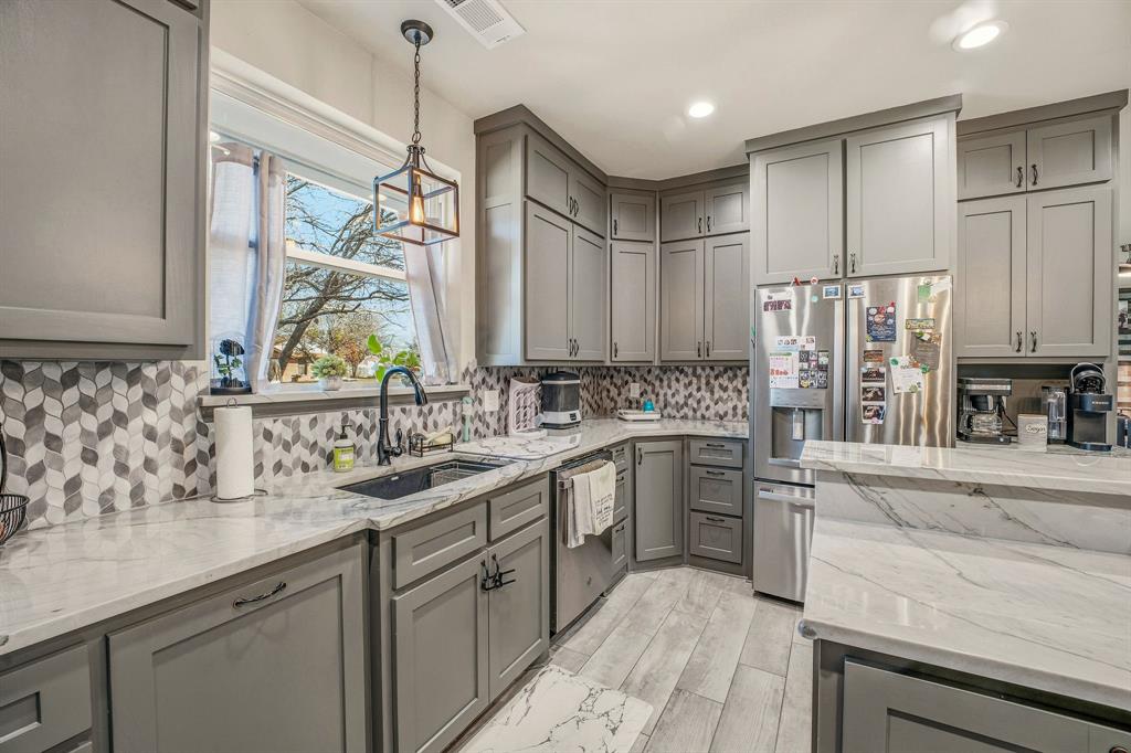 435 Edwards Drive Dublin, TX 76446 - Photo 13 of 40 a kitchen with stainless steel appliances granite countertop a sink stove and refrigerator