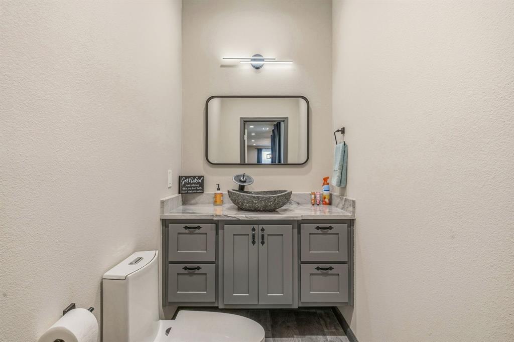435 Edwards Drive Dublin, TX 76446 - Photo 16 of 40 a bathroom with a toilet a sink and mirror