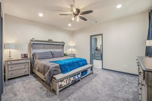 a bed room with a bed and a ceiling fan