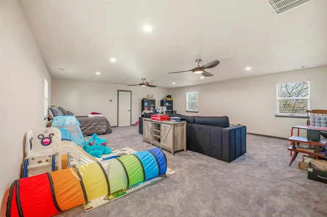 a bed room with a bed and a chair