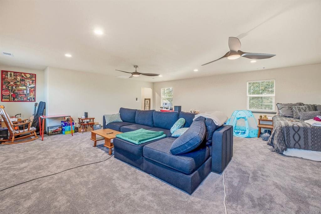 435 Edwards Drive Dublin, TX 76446 - Photo 26 of 40 a living room with furniture a ceiling fan and a window